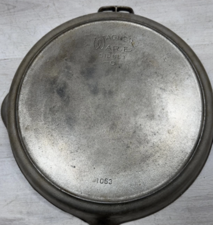 Bottom of Wagner nickel plated cast iron skillet number 12, catalog number 1063. Sold for $450.